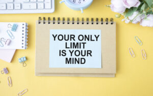 Inspirational motivational quotes on a white plate, your only limit is your mind against a yellow background.