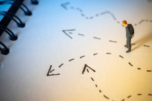 Business decision concept. Businessman thinking with many arrow path.